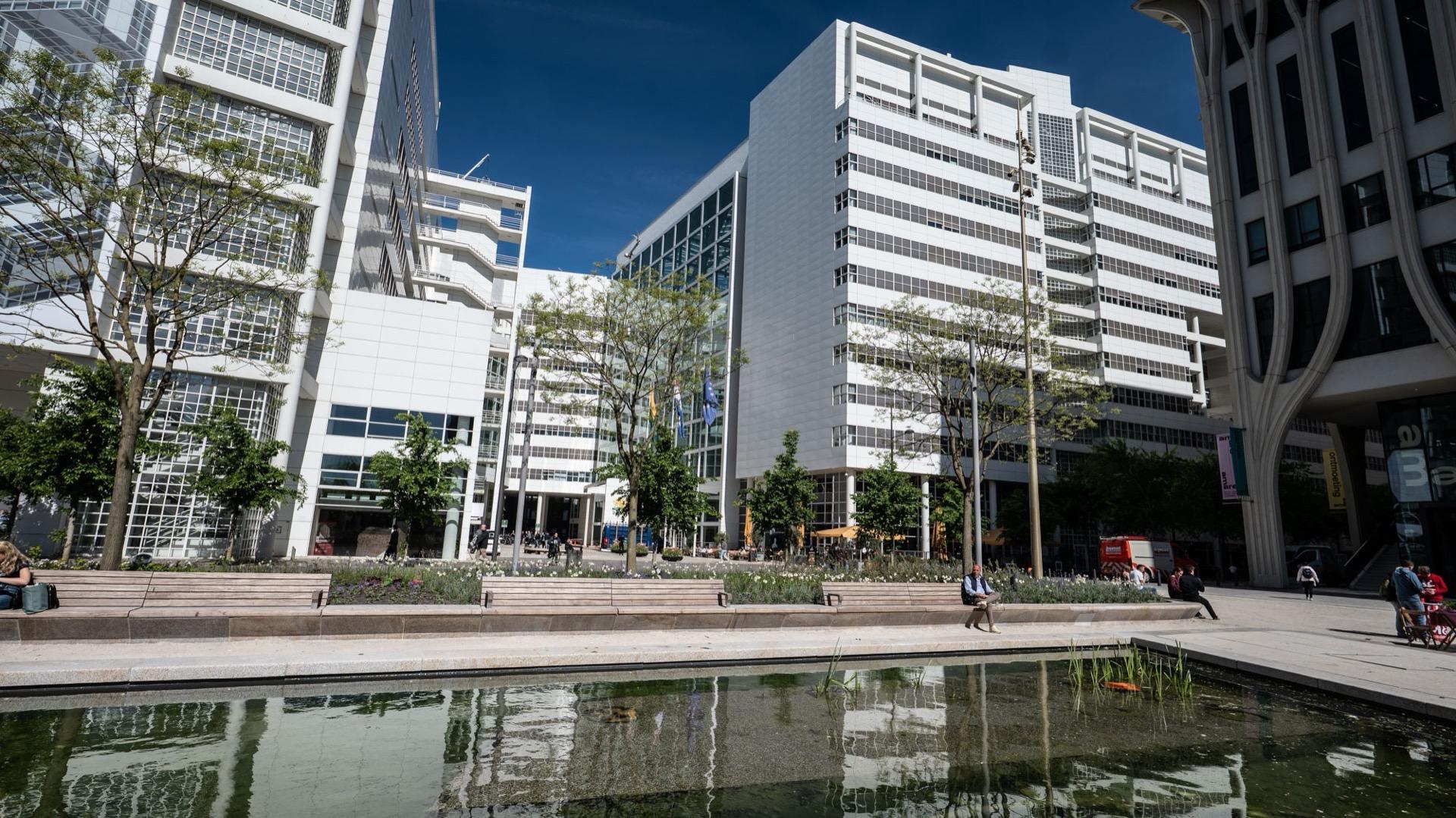 The white city hall of The Hague at the Spui, reflected in the water basin in front of it