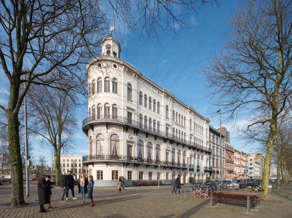 The white nineteenth century Wereldmuseum building on Willemskade in Rotterdam, with its rounded corner and clock tower